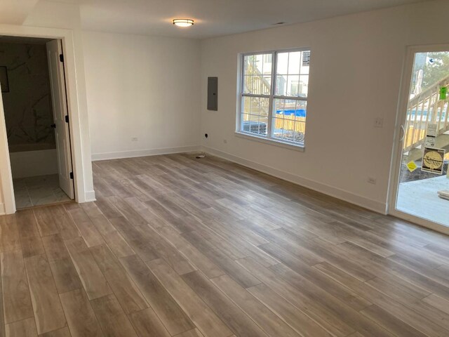 939 Saddle Ridge Dr, Joliet, IL 60432 - unfurnished room with wood finished floors, plenty of natural light, and electric panel