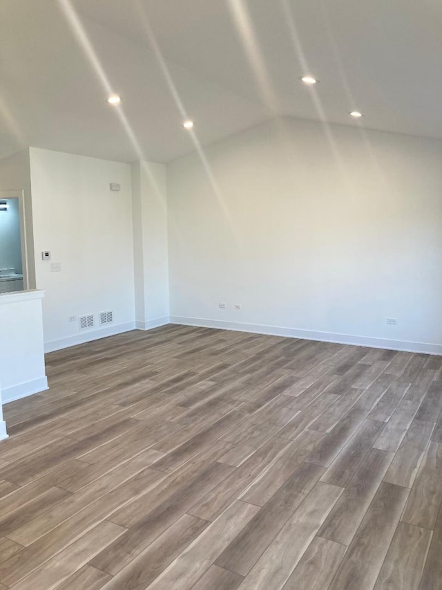 939 Saddle Ridge Dr, Joliet, IL 60432 - spare room featuring wood finished floors, lofted ceiling, and recessed lighting