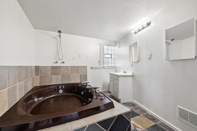16492 Brockton Ln, Oak Forest, IL 60452 - full bathroom with a jetted tub, vanity, and stone finish flooring