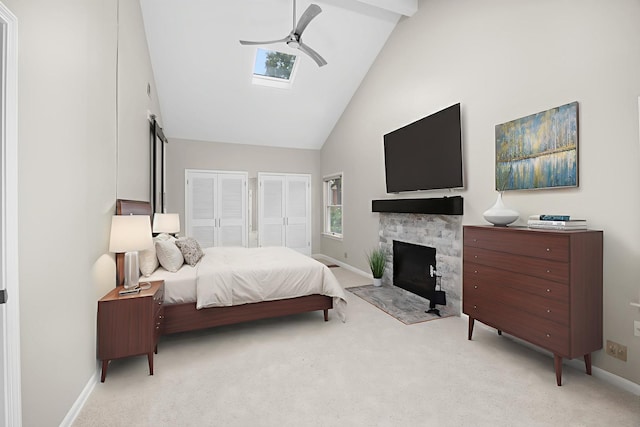 4416 Seeley Ave, Downers Grove, IL 60515 - carpeted bedroom featuring high vaulted ceiling, two closets, ceiling fan, a fireplace, and a skylight