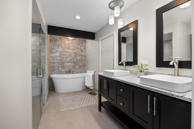4416 Seeley Ave, Downers Grove, IL 60515 - full bathroom with double vanity, a soaking tub, wood finished floors, and a stall shower