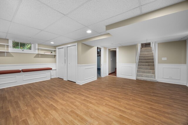 4416 Seeley Ave, Downers Grove, IL 60515 - basement with a paneled ceiling, light wood-type flooring, a wainscoted wall, stairway, and recessed lighting