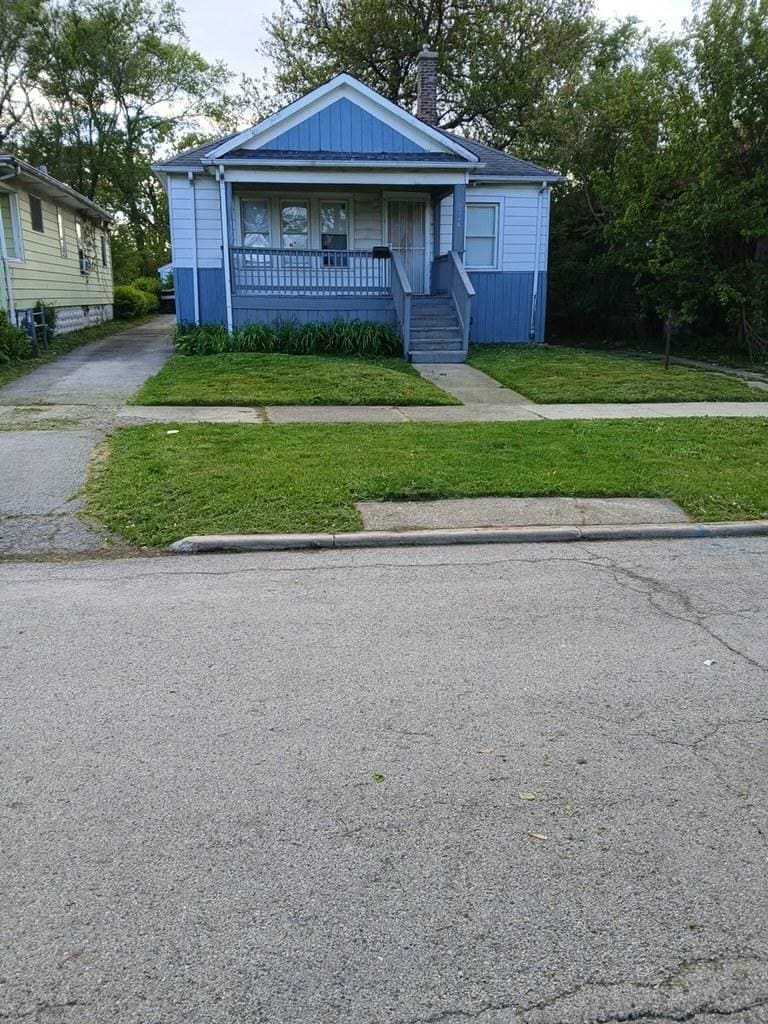 1326 Shields Ave, Chicago Heights, IL 60411 - bungalow-style home with a porch, a front lawn, and a chimney