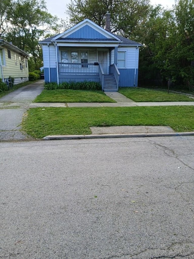 1326 Shields Ave, Chicago Heights, IL 60411 - bungalow-style home with a porch, a front lawn, and a chimney