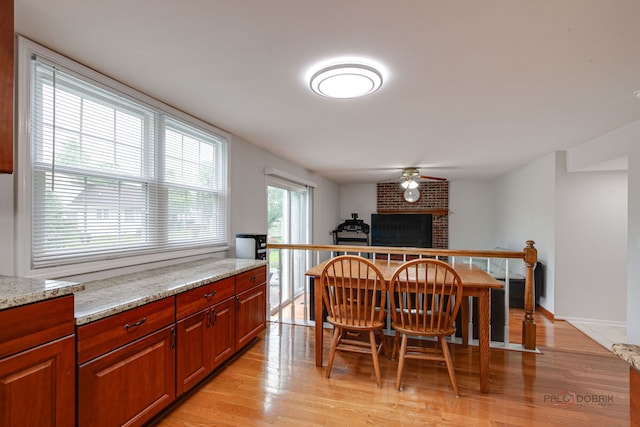 4900 Dukesberry Ln, Hoffman Estates, IL 60010 - dining space with light wood-type flooring, ceiling fan, and a brick fireplace