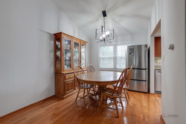 4900 Dukesberry Ln, Hoffman Estates, IL 60010 - dining room featuring a chandelier, light wood-style floors, lofted ceiling, and a textured ceiling