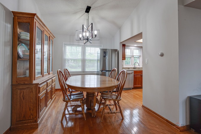 4900 Dukesberry Ln, Hoffman Estates, IL 60010 - dining area with a chandelier, light wood-type flooring, and vaulted ceiling