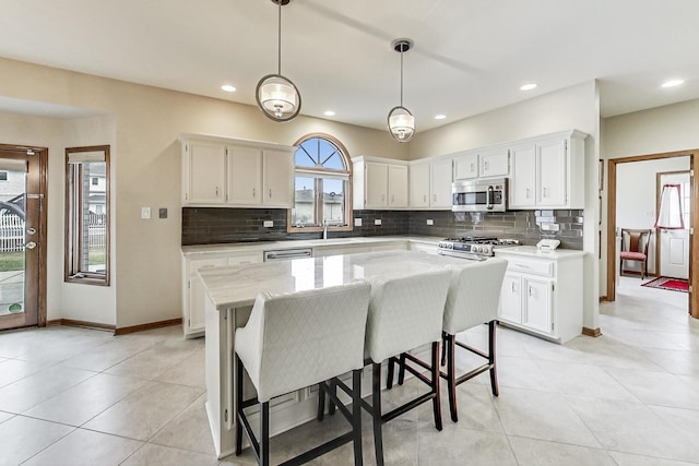 7830 W 157th St, Orland Park, IL 60462 - kitchen with appliances with stainless steel finishes, tasteful backsplash, white cabinets, and recessed lighting