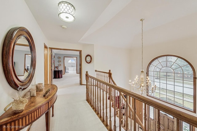 7830 W 157th St, Orland Park, IL 60462 - hallway with light carpet, an upstairs landing, and a chandelier