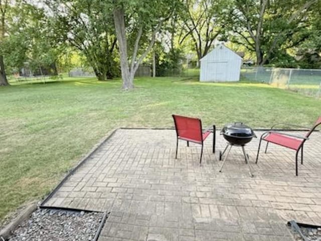 2017 E Sauk Trl, Sauk Village, IL 60411 - view of patio / terrace featuring a storage unit, a fire pit, grilling area, and view of scattered trees