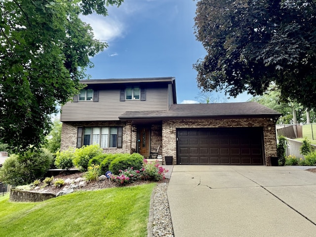 241 E Porter St, Oglesby, IL 61348 - view of front facade with an attached garage, concrete driveway, and brick siding