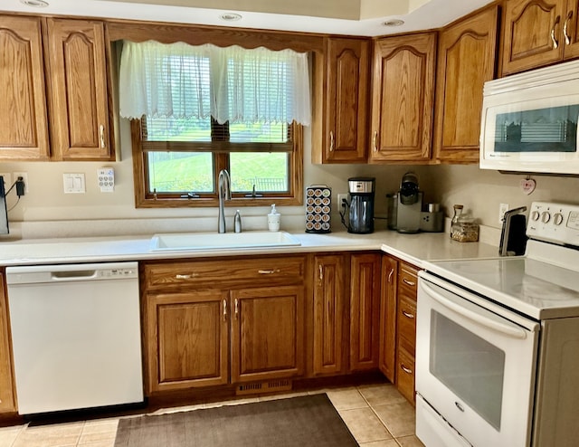 241 E Porter St, Oglesby, IL 61348 - kitchen with white appliances, brown cabinets, light tile patterned floors, and light countertops