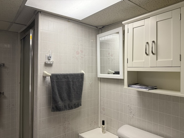 241 E Porter St, Oglesby, IL 61348 - bathroom featuring tile walls, a drop ceiling, and a shower