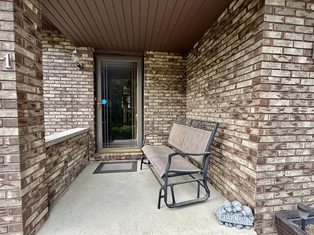 241 E Porter St, Oglesby, IL 61348 - doorway to property with brick siding and a porch