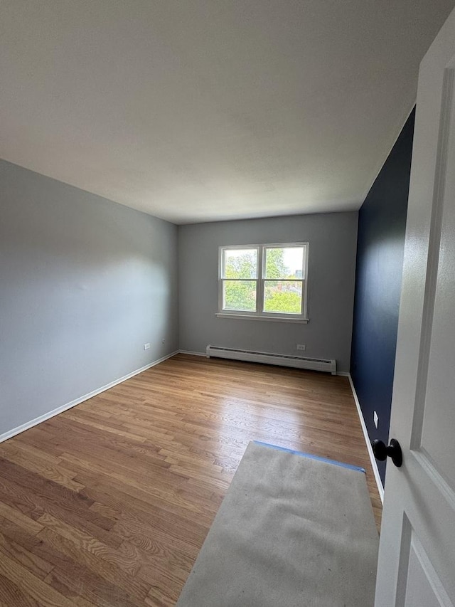7854 S S Shore Dr Unit 402, Chicago, IL 60649 - empty room featuring a baseboard radiator and wood finished floors