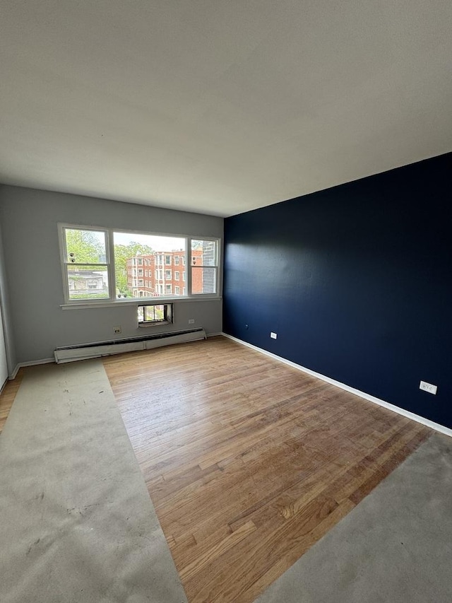 7854 S S Shore Dr Unit 402, Chicago, IL 60649 - unfurnished room featuring a baseboard heating unit and wood finished floors