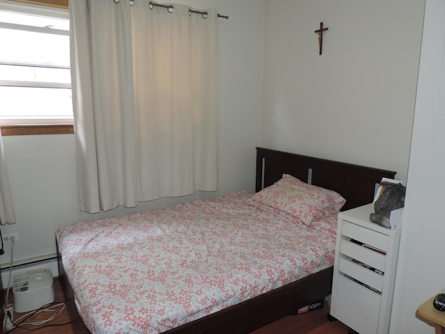 5063 N Menard Ave, Chicago, IL 60630 - bedroom with a baseboard radiator and dark wood finished floors