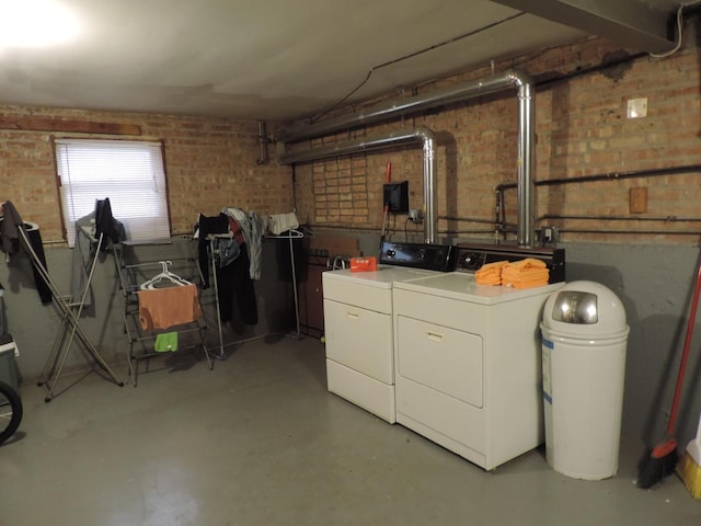 5063 N Menard Ave, Chicago, IL 60630 - laundry area with washer and clothes dryer and brick wall