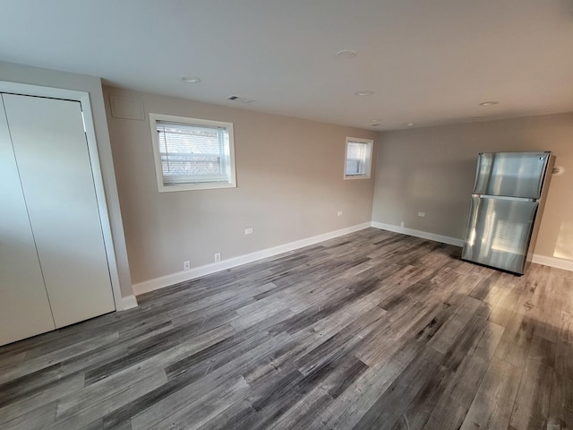 5063 N Menard Ave, Chicago, IL 60630 - unfurnished bedroom with freestanding refrigerator, dark wood-style floors, multiple windows, and recessed lighting