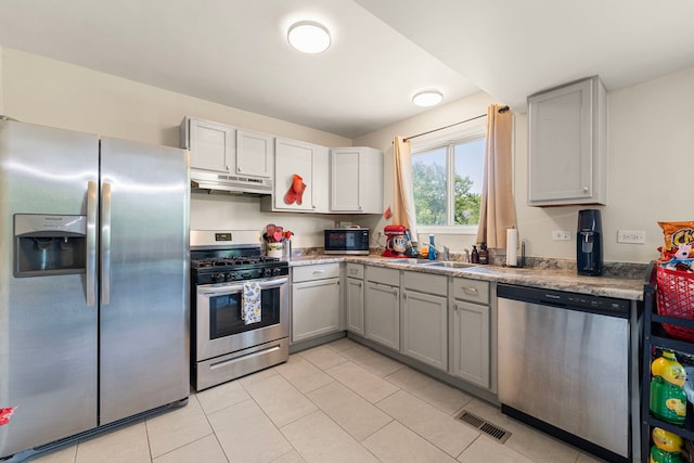 116 Cloverleaf Rd, Matteson, IL 60443 - kitchen featuring stainless steel appliances, gray cabinets, under cabinet range hood, and light tile patterned floors