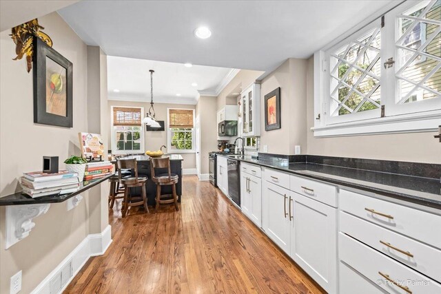 558 W Downer Pl, Aurora, IL 60506 - kitchen featuring dishwasher, light wood-type flooring, crown molding, white cabinetry, and plenty of natural light