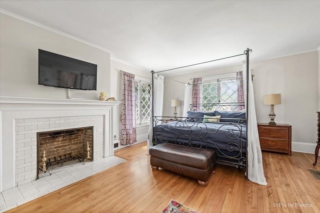 558 W Downer Pl, Aurora, IL 60506 - bedroom with ornamental molding, wood-type flooring, and a brick fireplace