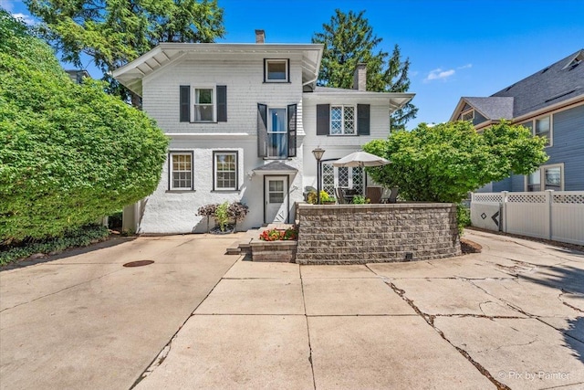 558 W Downer Pl, Aurora, IL 60506 - view of front of house with a chimney and a patio
