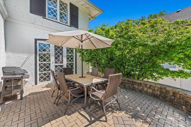 558 W Downer Pl, Aurora, IL 60506 - view of patio featuring outdoor dining space and a grill