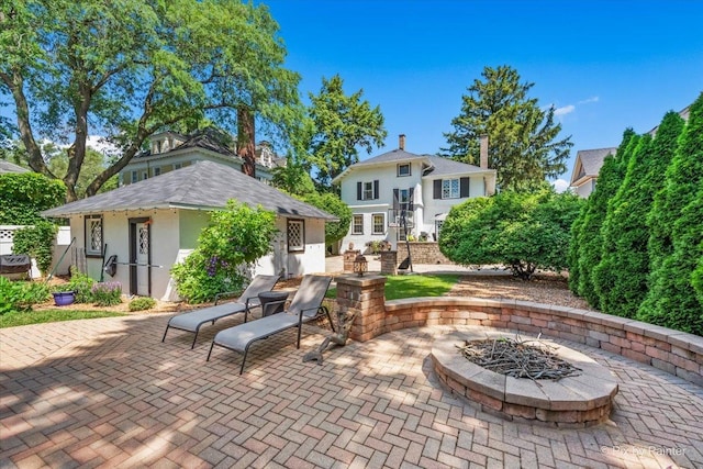 558 W Downer Pl, Aurora, IL 60506 - view of patio featuring an outdoor fire pit and an outbuilding