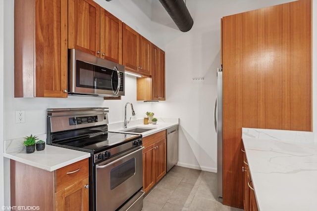 331 S Peoria St Unit Ph6, Chicago, IL 60607 - kitchen featuring stainless steel appliances, brown cabinetry, light tile patterned floors, and light stone counters