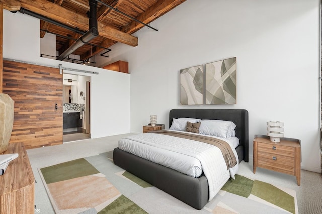 331 S Peoria St Unit Ph6, Chicago, IL 60607 - carpeted bedroom with a barn door and a wooden ceiling with exposed beams