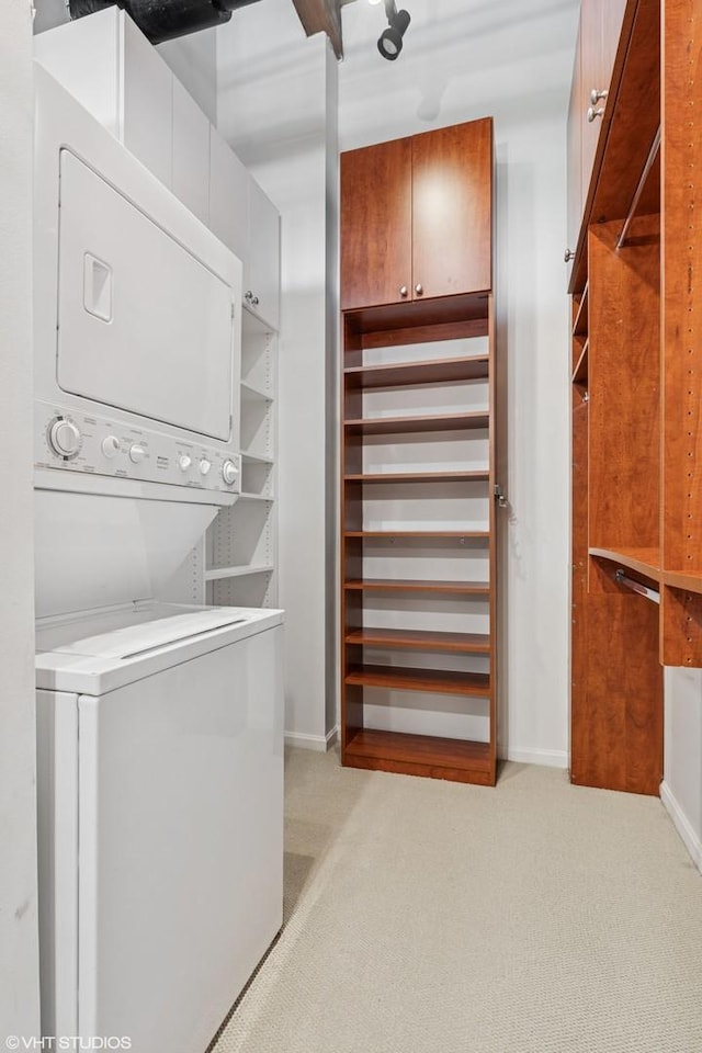 331 S Peoria St Unit Ph6, Chicago, IL 60607 - walk in closet with stacked washer and clothes dryer and light carpet