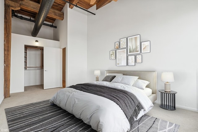 331 S Peoria St Unit Ph6, Chicago, IL 60607 - bedroom with carpet, a towering ceiling, a closet, and a wooden ceiling with exposed beams