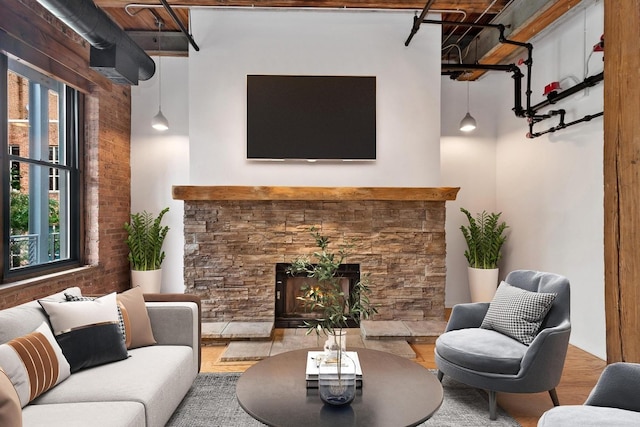 331 S Peoria St Unit Ph6, Chicago, IL 60607 - living area featuring a stone fireplace, a high ceiling, and wood finished floors