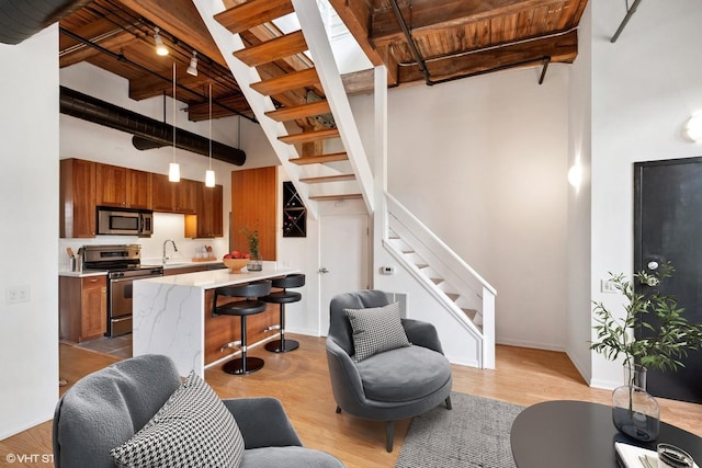 331 S Peoria St Unit Ph6, Chicago, IL 60607 - living area featuring a high ceiling, stairway, a wood ceiling with exposed beams, and light wood-type flooring