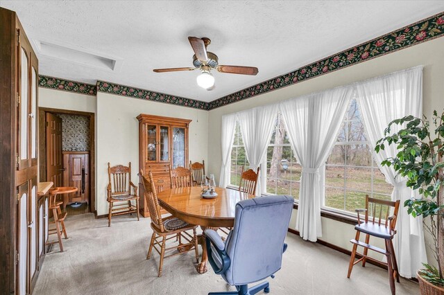 13809 Pine Rd, Dewitt, IL 61735 - dining room featuring light colored carpet, a textured ceiling, and a ceiling fan