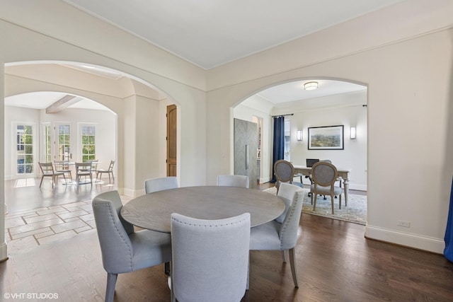 437 N County Line Rd, Hinsdale, IL 60521 - dining room featuring arched walkways, ornamental molding, and dark wood-type flooring