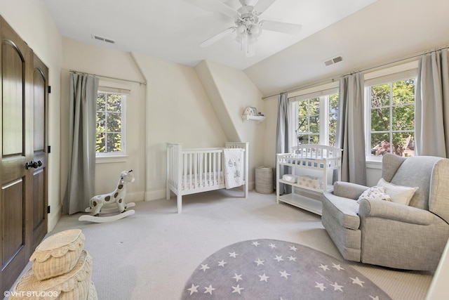 437 N County Line Rd, Hinsdale, IL 60521 - carpeted bedroom with multiple windows, vaulted ceiling, ceiling fan, and a crib