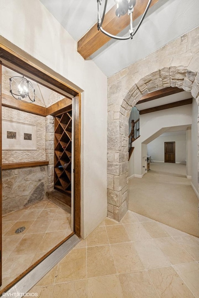 437 N County Line Rd, Hinsdale, IL 60521 - wine area featuring arched walkways, a chandelier, carpet flooring, and beamed ceiling