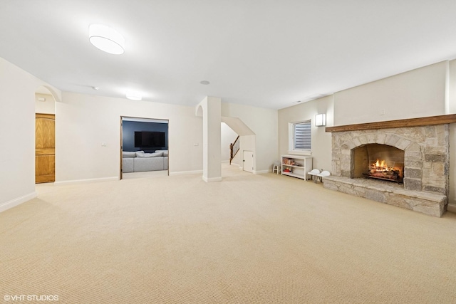 437 N County Line Rd, Hinsdale, IL 60521 - unfurnished living room with carpet floors, a fireplace, arched walkways, and stairway