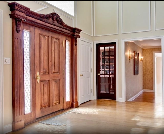 1400 Arbor Ln, Lake Forest, IL 60045 - entryway with wood finished floors, healthy amount of natural light, a towering ceiling, and crown molding