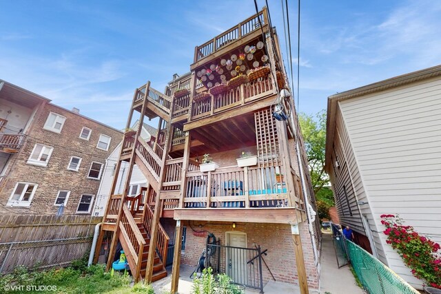 3253 W Leland Ave Unit 2, Chicago, IL 60625 - rear view of property with stairs, a deck, and brick siding