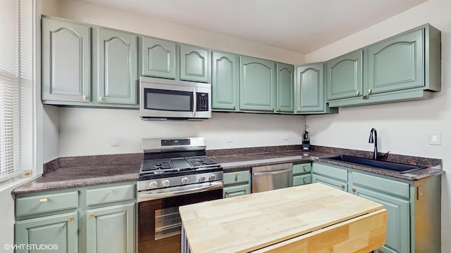 3253 W Leland Ave Unit 2, Chicago, IL 60625 - kitchen with appliances with stainless steel finishes and green cabinets