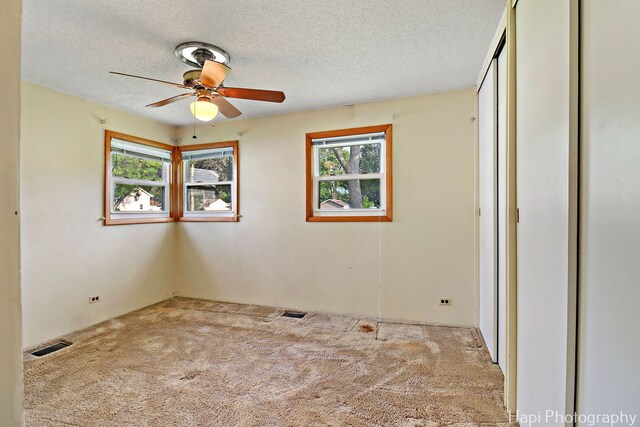 2310 Eastman St, Rolling Meadows, IL 60008 - unfurnished room featuring carpet floors, a ceiling fan, and a textured ceiling