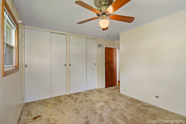 2310 Eastman St, Rolling Meadows, IL 60008 - unfurnished bedroom with carpet floors, two closets, and a ceiling fan