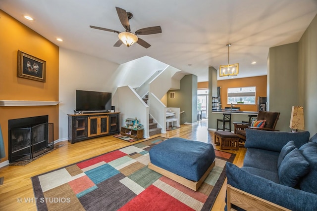 108 Belvidere Ave, Forest Park, IL 60130 - living room featuring stairs, wood finished floors, recessed lighting, a fireplace with flush hearth, and ceiling fan
