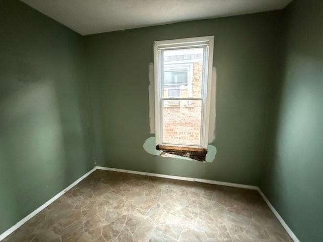 4904 W 31st St, Cicero, IL 60804 - spare room with baseboards and stone finish floors