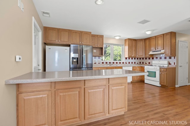 7334 Maridon Rd, Countryside, IL 60525 - kitchen featuring white appliances, under cabinet range hood, a peninsula, and light countertops