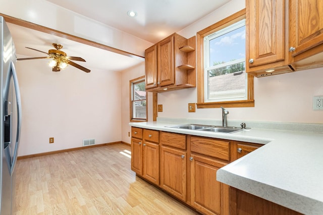 230 Brierhill Dr, Round Lake Park, IL 60073 - kitchen with stainless steel refrigerator with ice dispenser, plenty of natural light, light countertops, and light wood-style floors