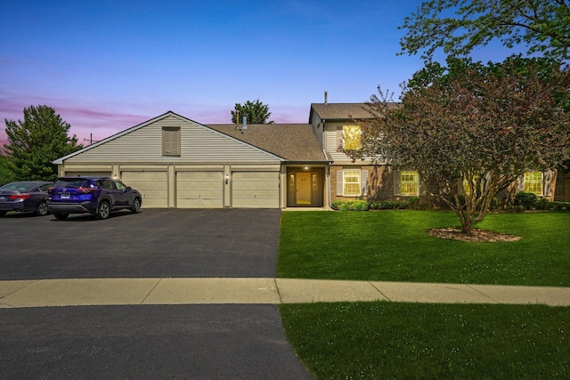 240 Crestview Dr Unit B, Wauconda, IL 60084 - view of front of home with a front lawn, a garage, asphalt driveway, roof with shingles, and brick siding